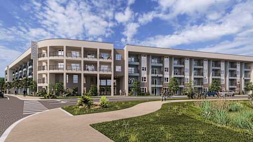 A modern apartment building with a walkway in front.