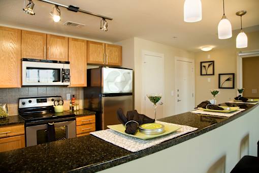 a kitchen with granite counter tops and stainless steel appliances