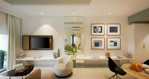 A modern living room with a flat screen TV mounted on the wall.