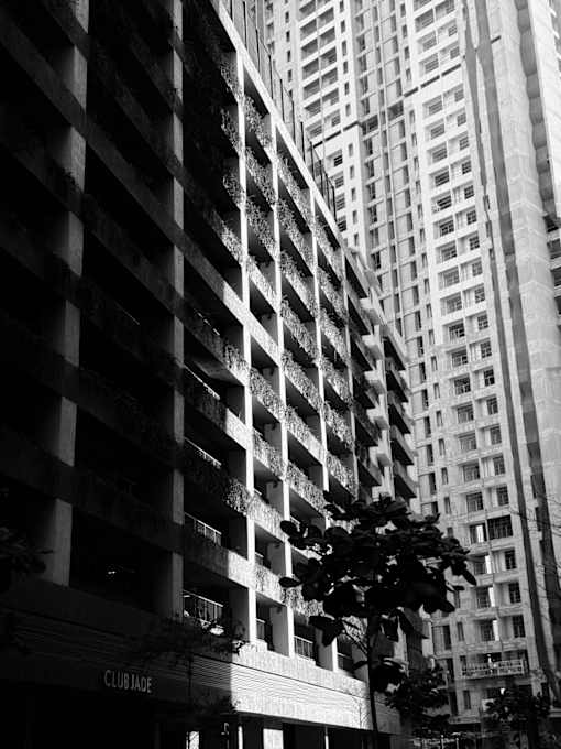 A black and white photo of a building with the word "Club" on the front.