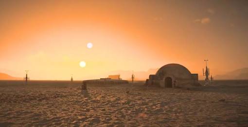 A desert landscape with a sunset and a large dome-like structure.