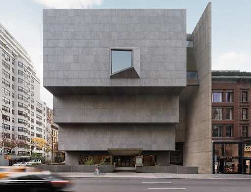 A modern building with a large window on the front.