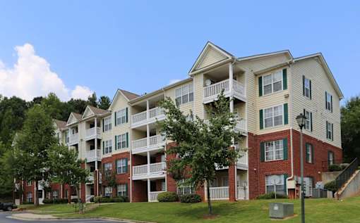 an exterior view of an apartment building on a sunny day