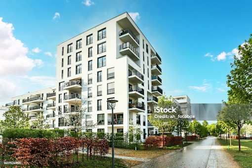 A modern apartment building with a clear blue sky above.