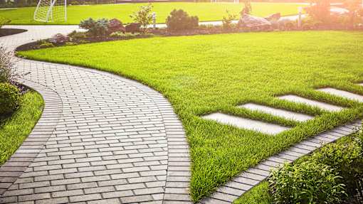 a path in the grass with grass symbols on the ground