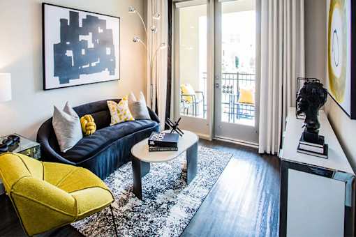 a living room with a black couch and a coffee table