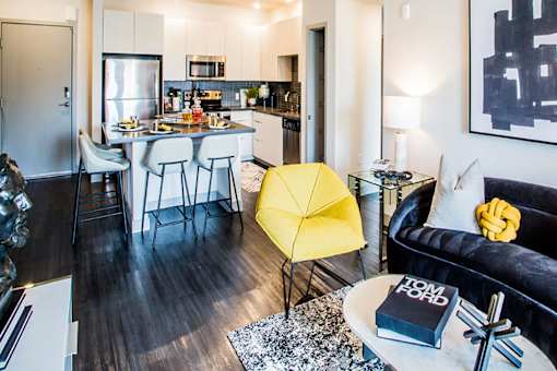 a living room and kitchen with a couch and a table