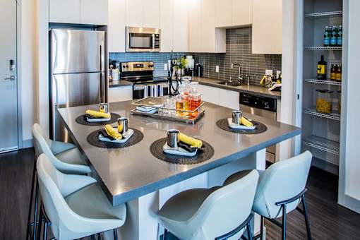 a kitchen with a large island with plates of food on it