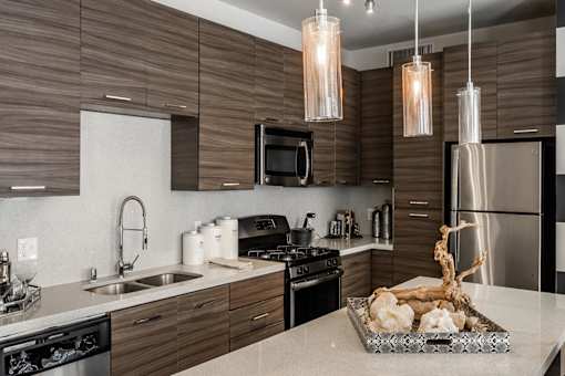 a kitchen with stainless steel appliances and wooden cabinets