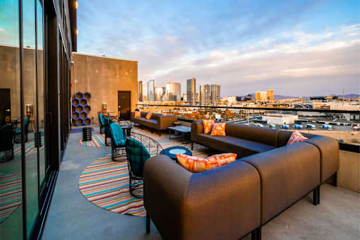 a roof top bar with a view of the city