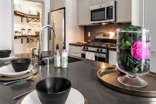 a kitchen with a sink and a counter top with a vase of flowers