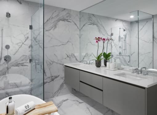a white bathroom with a sink and a shower