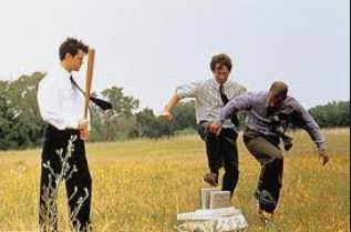 three men in a field playing a game of baseball