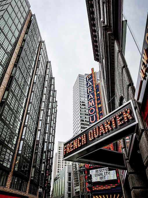 A sign for the Chinatown Quarter is displayed in front of a building.