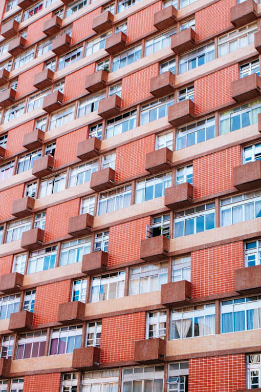 the facade of a building with red bricks and windows