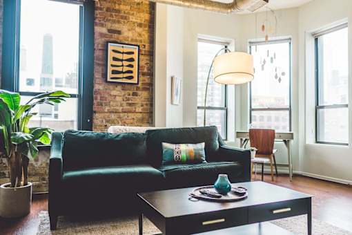 a living room with a green couch and a coffee table