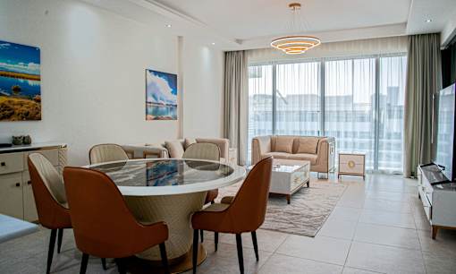 A modern dining room with a round table and chairs.