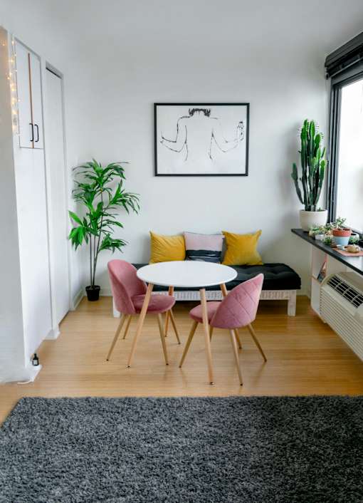 A dining room with a white table and chairs.