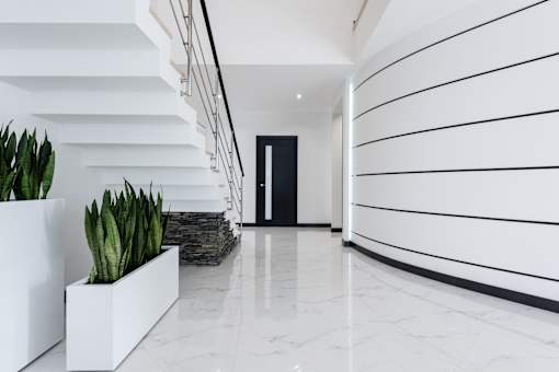A long hallway with a black door at the end.