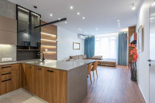 A modern kitchen with wooden cabinets and a large island.