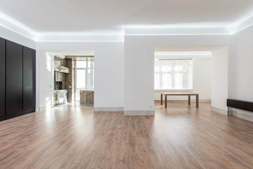 A room with wooden floors and white walls.