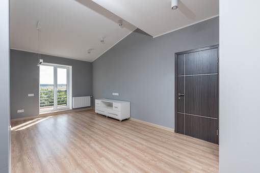 A room with wooden floors and a white cabinet.