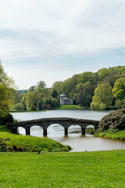 a view of cliveden house from across the lake