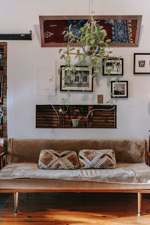 a living room with a couch and pictures on the wall