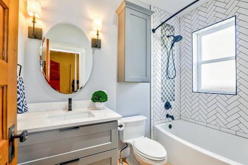 A bathroom with a white sink and a white toilet.