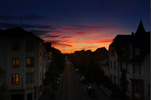 a sunset over a city street