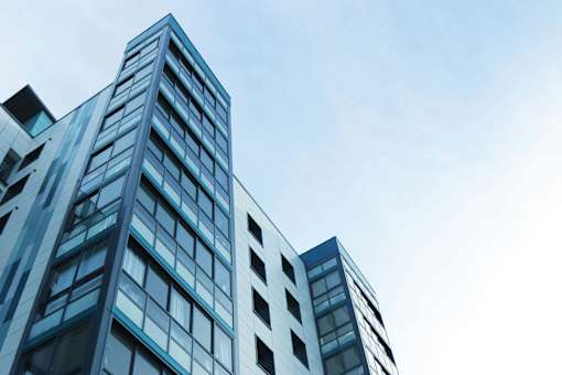 A tall building with many windows and balconies.