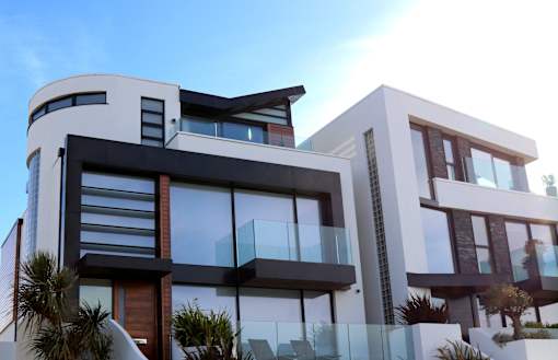 A modern house with a curved design and large windows.