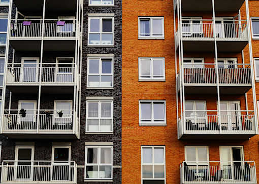 A tall building with balconies and windows.