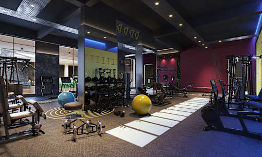 A gym with a variety of equipment including weights and exercise balls.