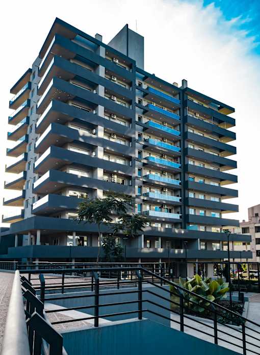 A modern building with a balcony in front.