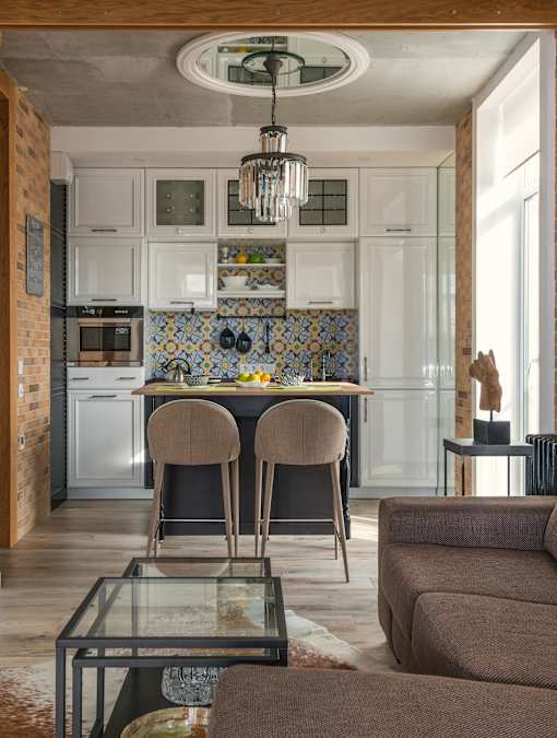 A kitchen with a table and chairs in the middle of the room.