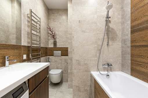 A modern bathroom with a white sink, a white toilet, and a white bathtub.