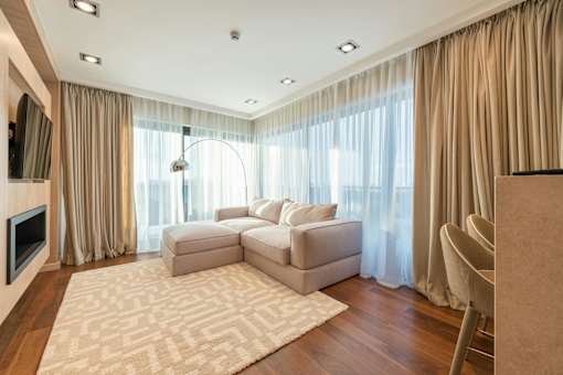 A living room with a large sectional sofa and a television.