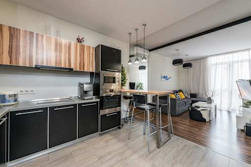 a kitchen with a bar and a living room with a couch