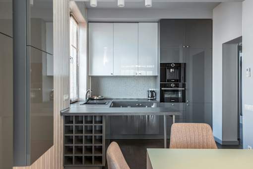 A modern kitchen with a dining table and chairs.