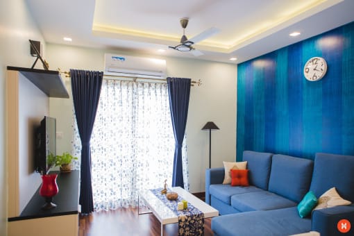 a living room with a blue couch and a coffee table