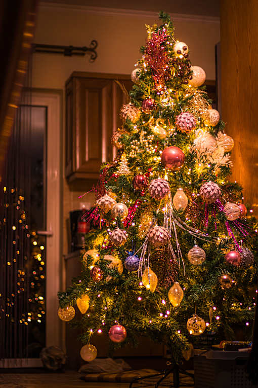 A beautifully decorated Christmas tree with a variety of ornaments.