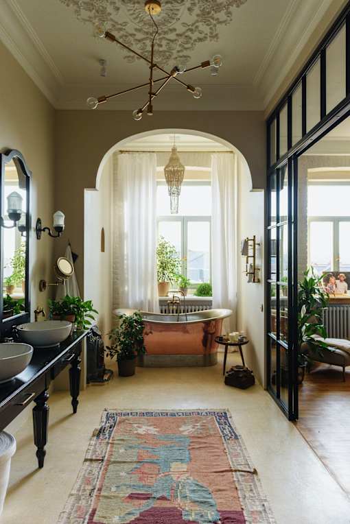 a bathroom with a bathtub and a window
