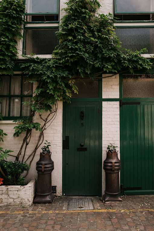 a green door on a white brick building