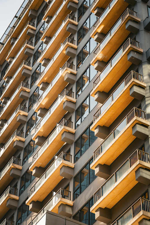 A tall building with balconies on each floor.