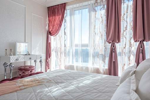 a bedroom with a large bed in front of a window