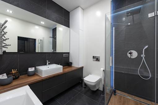 a close up of a bathroom with a toilet sink and shower