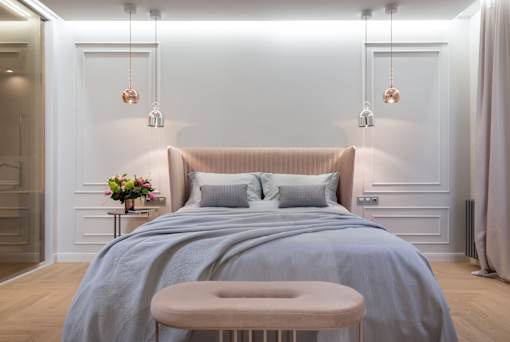 a bedroom with a bed and a stool in a 555 waverly unit
