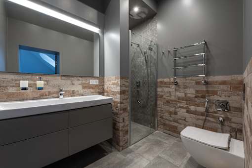 a bathroom with a glass shower stall and a toilet