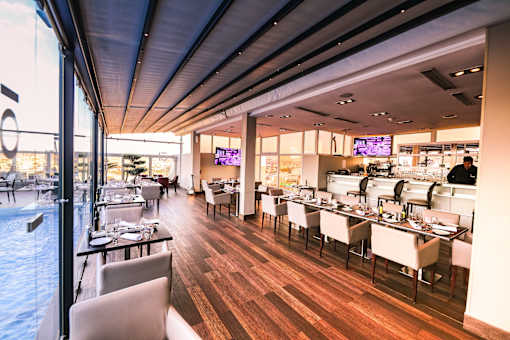 a restaurant with a wooden floor and a large window